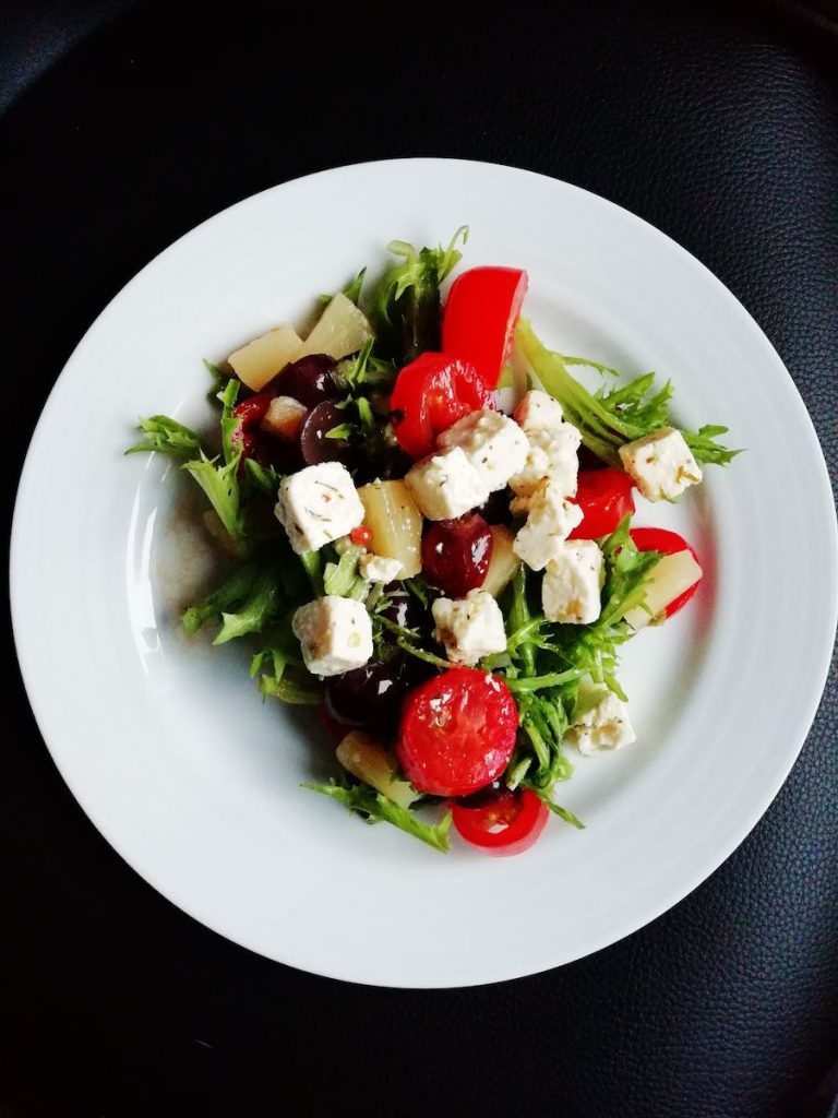 Eating healthy foods with portion control is a great combination- Vegetable Salad on White Ceramic Plate