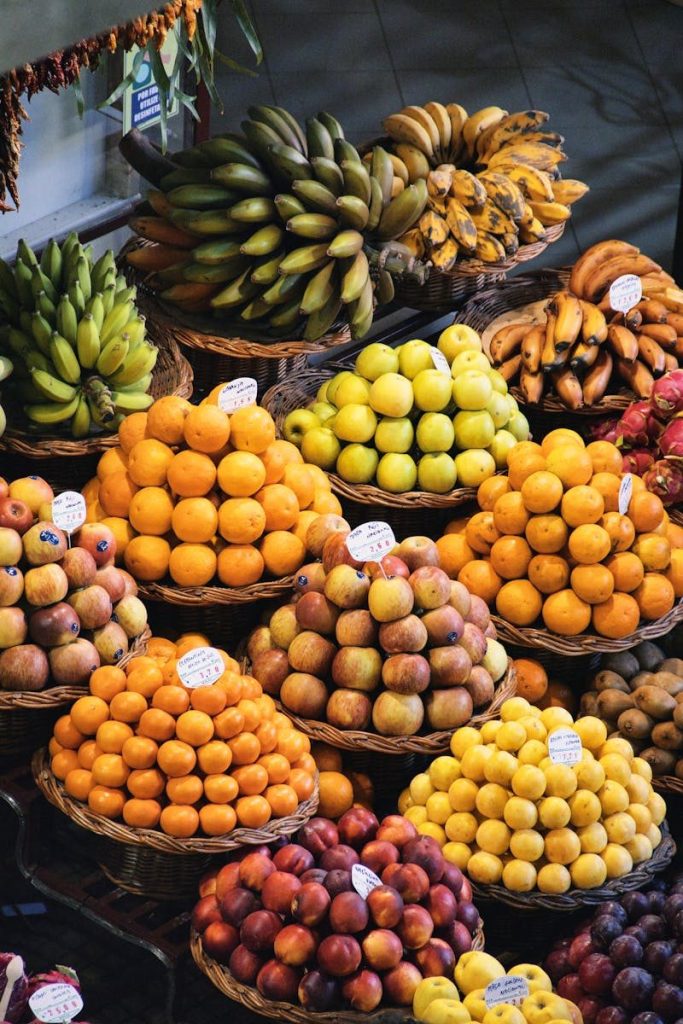 Colorful array of fruits at a traditional market in Funchal, Madeira showcasing local produce.